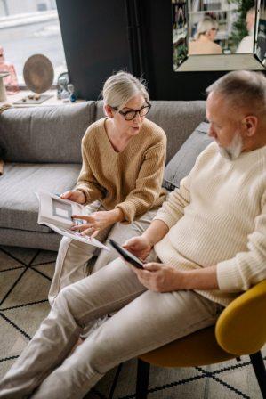 a group of people sitting on a couch talking